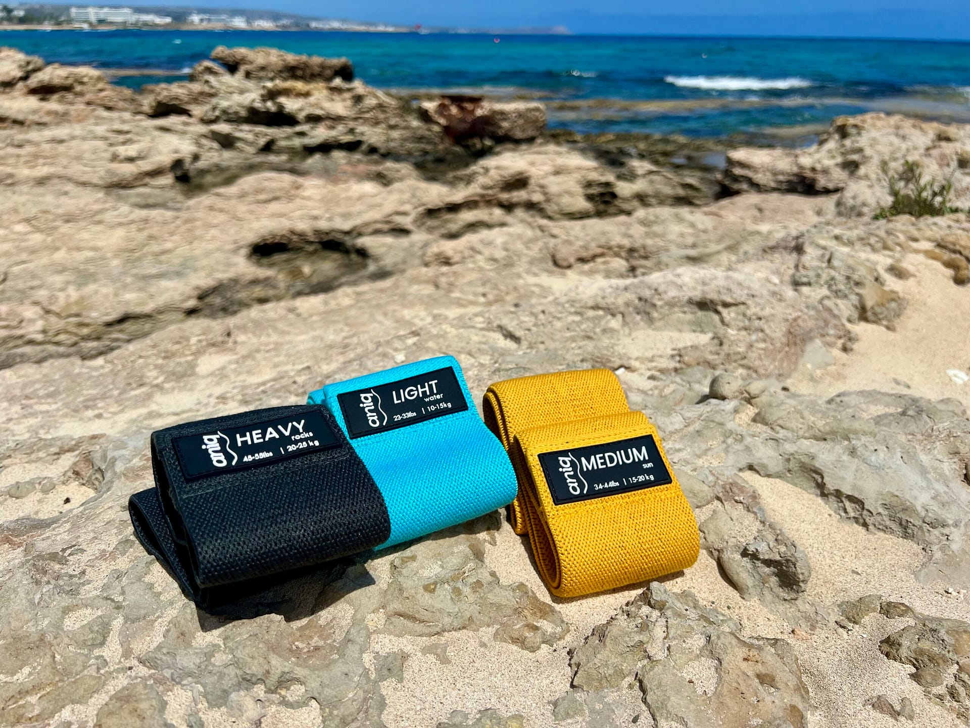 ANIQ fabric resistance bands on the rocks by the sea